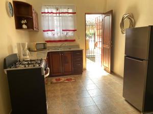 a kitchen with a stove and a refrigerator at Studio Unit in Beautiful Resort in El Mangote