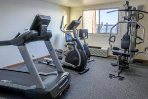 a gym with exercise bikes and a treadmill at Lighthouse Inn - Two Rivers in Two Rivers