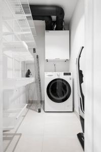 a laundry room with a washing machine and a staircase at W Apartments Loft in Kalamaja in Tallinn
