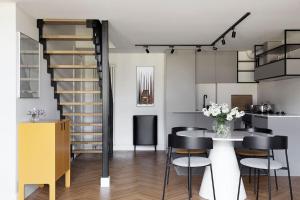 a kitchen and dining room with a table and chairs at W Apartments Loft in Kalamaja in Tallinn