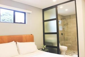 a bedroom with a shower and a bed and a toilet at 574 Hotel in Medellín +70 photos