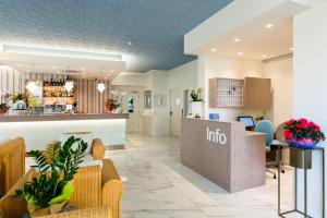 an inside view of a hotel lobby with a reception counter at Hotel Victoria in Bibione