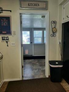 a hallway with a door leading to a kitchen at Mi Casa, Tu Casa in Rupert
