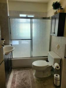 a bathroom with a toilet and a sink and a shower at Mi Casa, Tu Casa in Rupert +9 photos