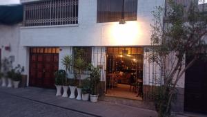 a building with a front door with potted plants at Il Riposo in Arequipa