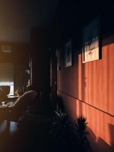 a dark living room with a couch and a wall at El Refugio - Hotel Mariscala in Mariscala