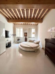 a bedroom with a large bed and a wooden ceiling at Luxury Tower House in heart of Pisa in Pisa