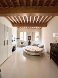 a bedroom with a large bed and a wooden ceiling at Luxury Tower House in heart of Pisa in Pisa