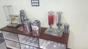 a wooden shelf with a bunch of blenders on it at Hotel La Gowri, Coorg in Madikeri