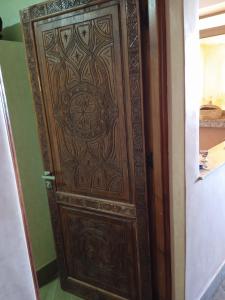a wooden door with a design on it at Résidence Perle De L'océan B.M.L in Mirleft