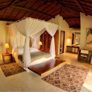 a bedroom with a large bed with a canopy at Camauí Hotel in Barra Grande