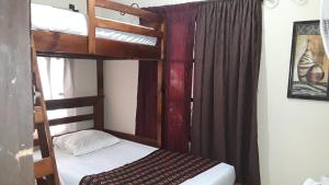 a bedroom with a bunk bed and a bunk bedouble at HOTEL EL ALMENDRO in Copan Ruinas