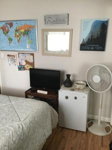 a bedroom with a bed and a desk with a fan at Clovis, CA National Parks Room in Clovis