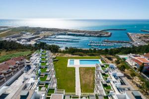 an aerial view of apartment buildings and the ocean at Mar a Vista - Condominium with Pool, Gym and Sea Views in Nazaré
