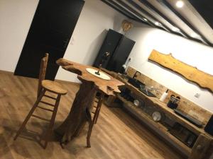 a wooden table in a room with a counter at Détour d’un soir… in Saint-Inglevert