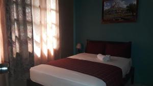 Rúm í herbergi á HOTEL EL ALMENDRO