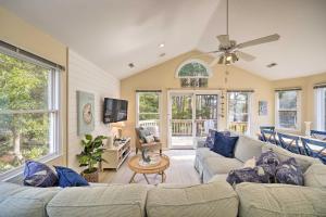 a living room with two couches and a ceiling fan at Coastal Home with Community Pool Less Than 2 Miles to Beach! in Corolla