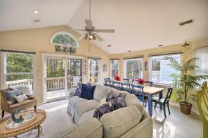 a living room with a couch and a table at Coastal Home with Community Pool Less Than 2 Miles to Beach! in Corolla