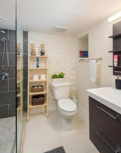 a bathroom with a toilet and a sink and a shower at Sunrise on Lake Washington in Seattle