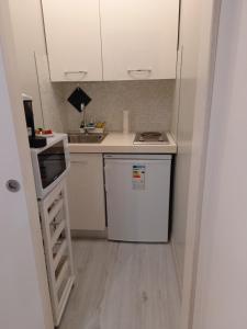 a small kitchen with a stove and a refrigerator at Casanova Apartment in Venice