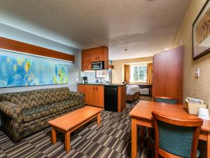 a living room with a couch and a table at Microtel Inn and Suites Ocala in Ocala