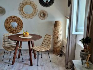 una sala da pranzo con tavolo, sedie e specchi di Mare è rocca a Bonifacio