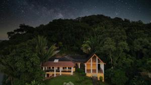 a house on a hill under a starry sky at Casa Varuna - 2 Bedrooms in West End