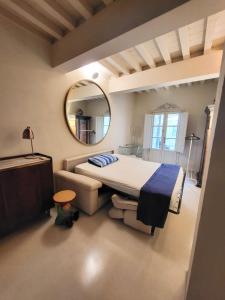 a bedroom with a large bed and a mirror at Luxury Tower House in heart of Pisa in Pisa