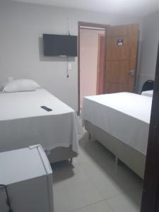 a hospital room with two beds and a door at HOTEL CAPITAL PALMAS in Palmas