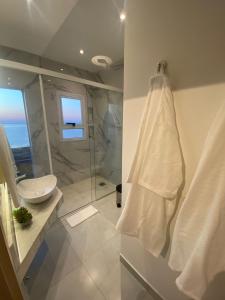 baño blanco con ducha y lavamanos en 25 homeApart en Encarnación
