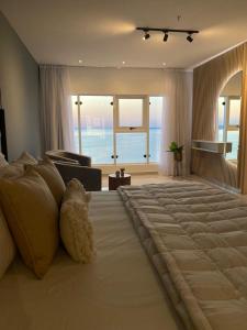 a bedroom with a large bed with a view of the ocean at 25 homeApart in Encarnación +80 photos
