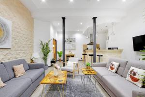 a living room with a couch and a table at Beautiful flat in the heart of the Marais in Paris