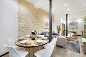 a dining room and living room with a table and chairs at Beautiful flat in the heart of the Marais in Paris