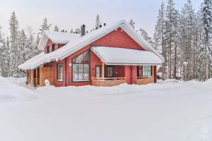a red cabin in the snow with trees at Holiday In Lapland - SointuiLevi B62 in Levi