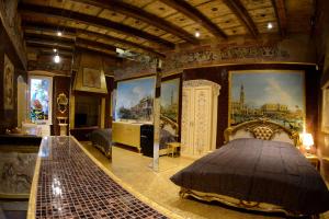 a bedroom with a bed and paintings on the walls at Il MOSAICO piccola spa in Verona