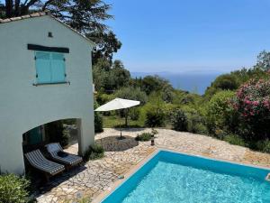 a villa with a swimming pool and a house at Villa „Sorbier“ mit Pool/ Meerblick an Côte d’Azur in Rayol-Canadel-sur-Mer