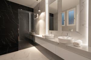 a white bathroom with two sinks and a mirror at Upscale Athens Luxury Penthouse in Athens