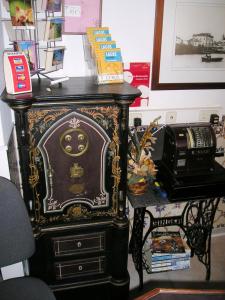 a black cabinet with a face on it next to a telephone at Solar de Mos in Lagos