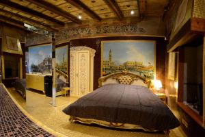 a bedroom with a bed and paintings on the walls at Il MOSAICO piccola spa in Verona