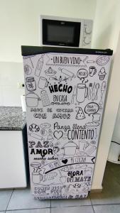 a refrigerator with drawings on it in a kitchen at Confortmdp apartamentos in Mar del Plata