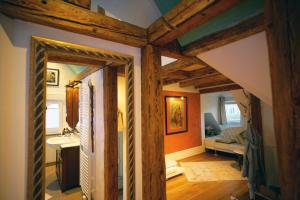 a room with wooden beams and a bathroom at Ferienwohnung Ambiente in Gaggenau