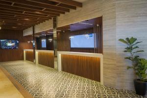 a row of stalls in a lobby with a potted plant at Oceano Palace in Mazatlán