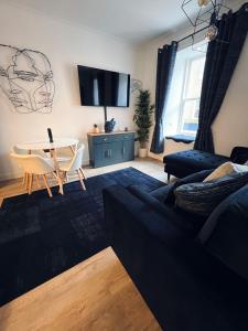 a living room with a couch and a table at Modern Town-Centre Apartment in Dumfries