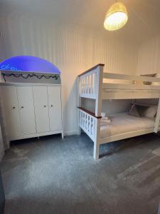 a baby room with a bunk bed and a crib at Modern Town-Centre Apartment in Dumfries