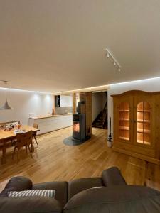 a living room and kitchen with a couch and a table at Ferienhaus Fuchseck in Bad Liebenzell