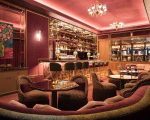 a restaurant with tables and chairs and a bar at Hotel Barrière Fouquet's New York in New York