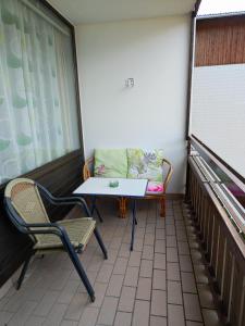 a balcony with a table and chairs and a couch at Ferienwohnung - Apartment Pichlarn Irdning in Aigen im Ennstal