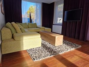 a living room with a couch and a coffee table at Our House in Breskens