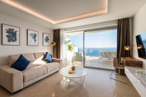 a living room with a couch and a table at Grand Horizon Luxury Boutique Apartments in Puerto Rico de Gran Canaria