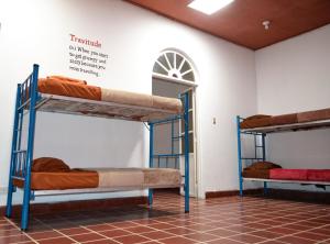two bunk beds in a room with a wall at 4 Grados Hostal in Guatemala